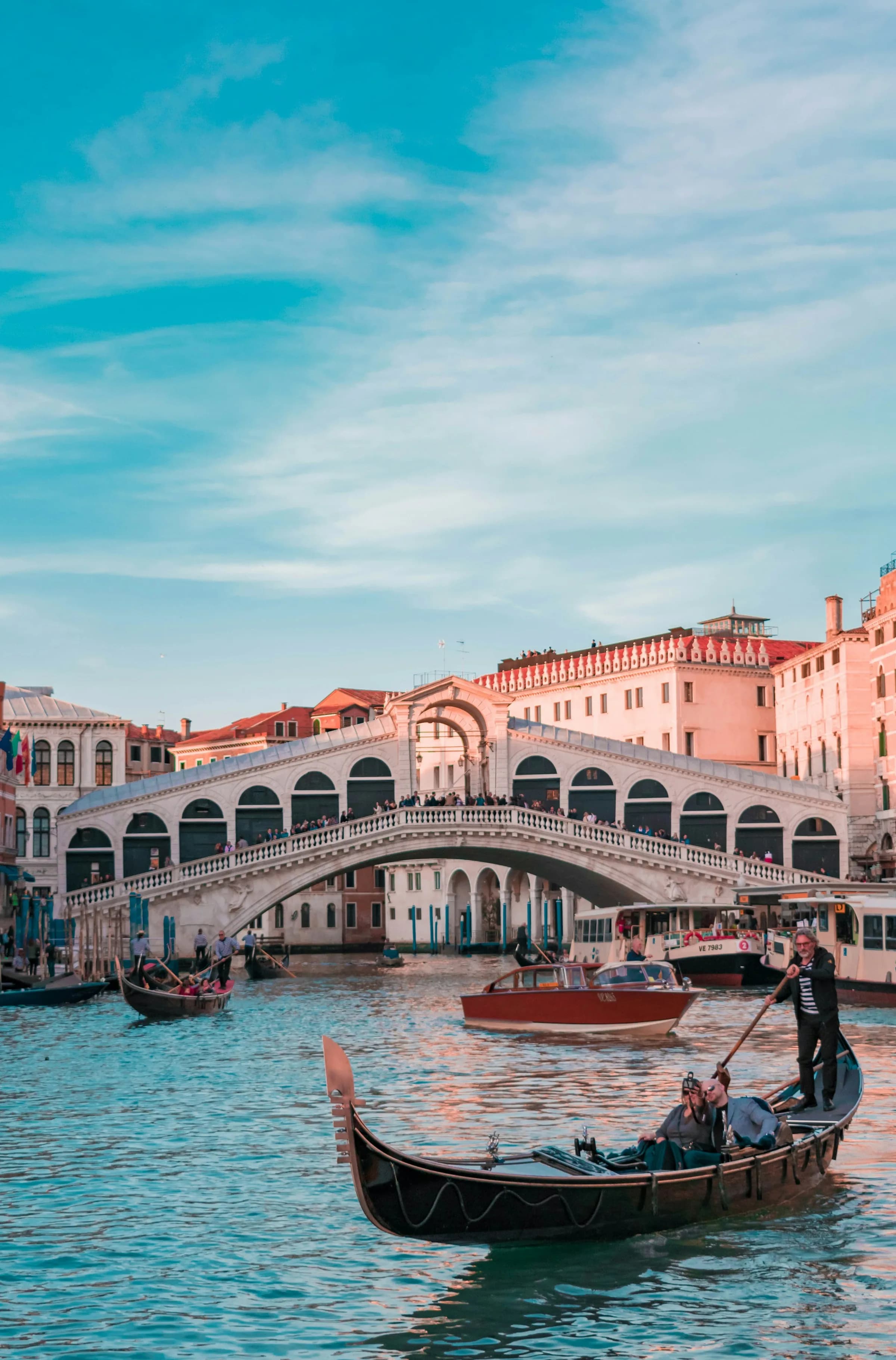 Venice canal with gondolas at dusk